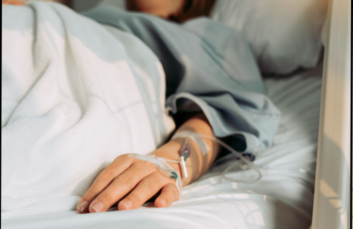 woman with IV lying in hospital bed